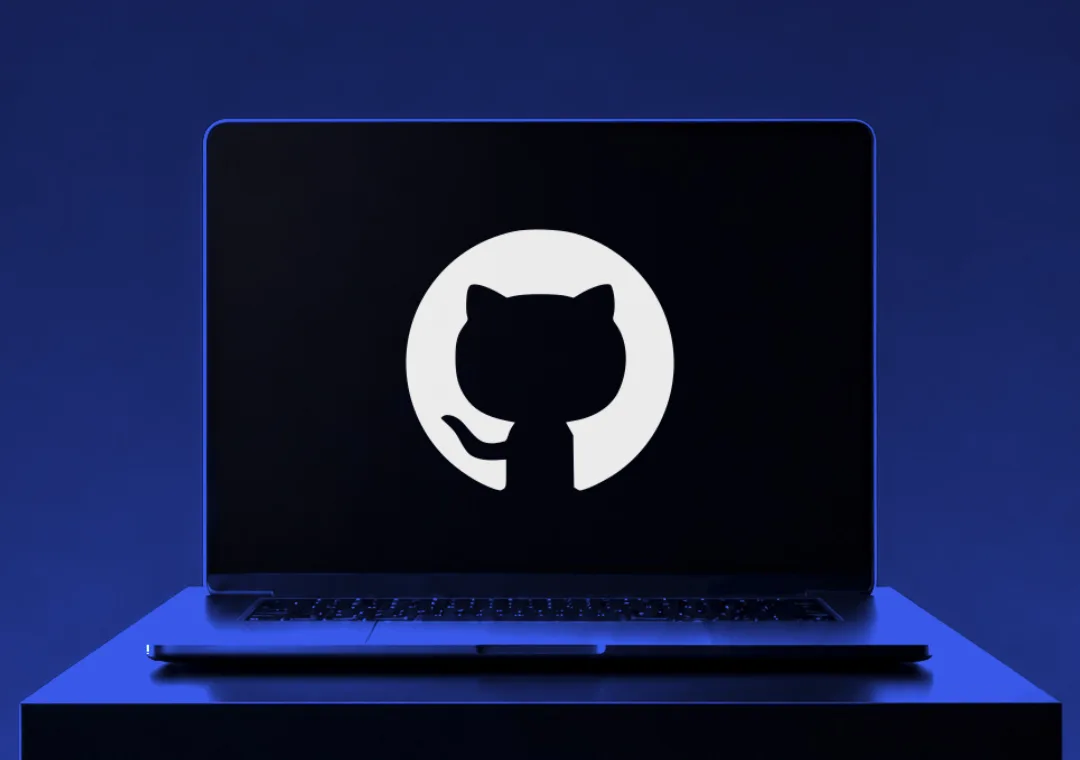A laptop on a plinth under blue light, the GitHub mark filling its screen.