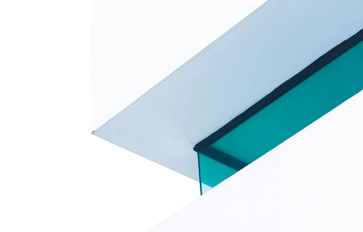Two white planes meeting on a single glass edge.